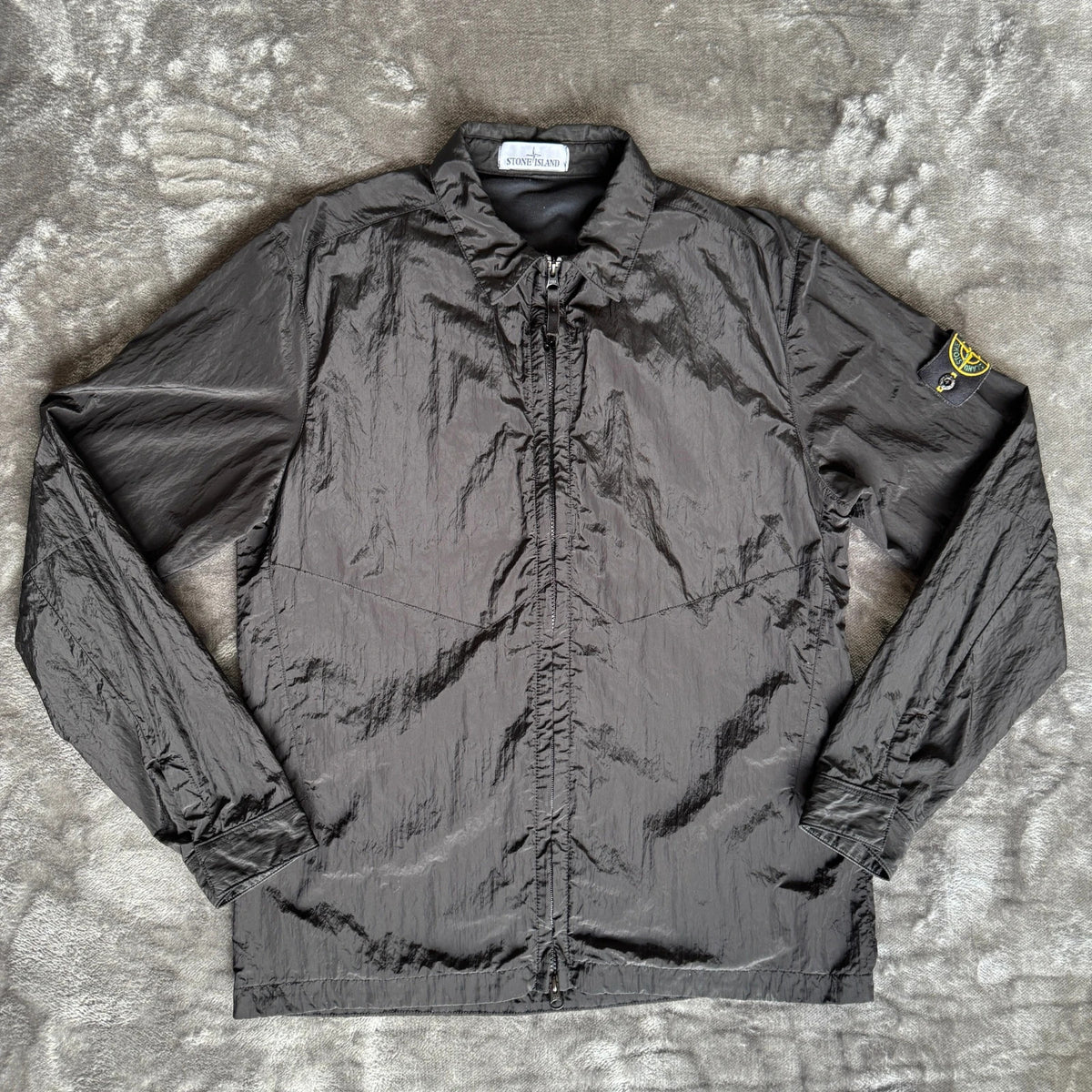 Stone Island black overshirt with logo badge and nylon metal material.