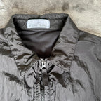 Stone Island black overshirt with logo badge and nylon metal material.