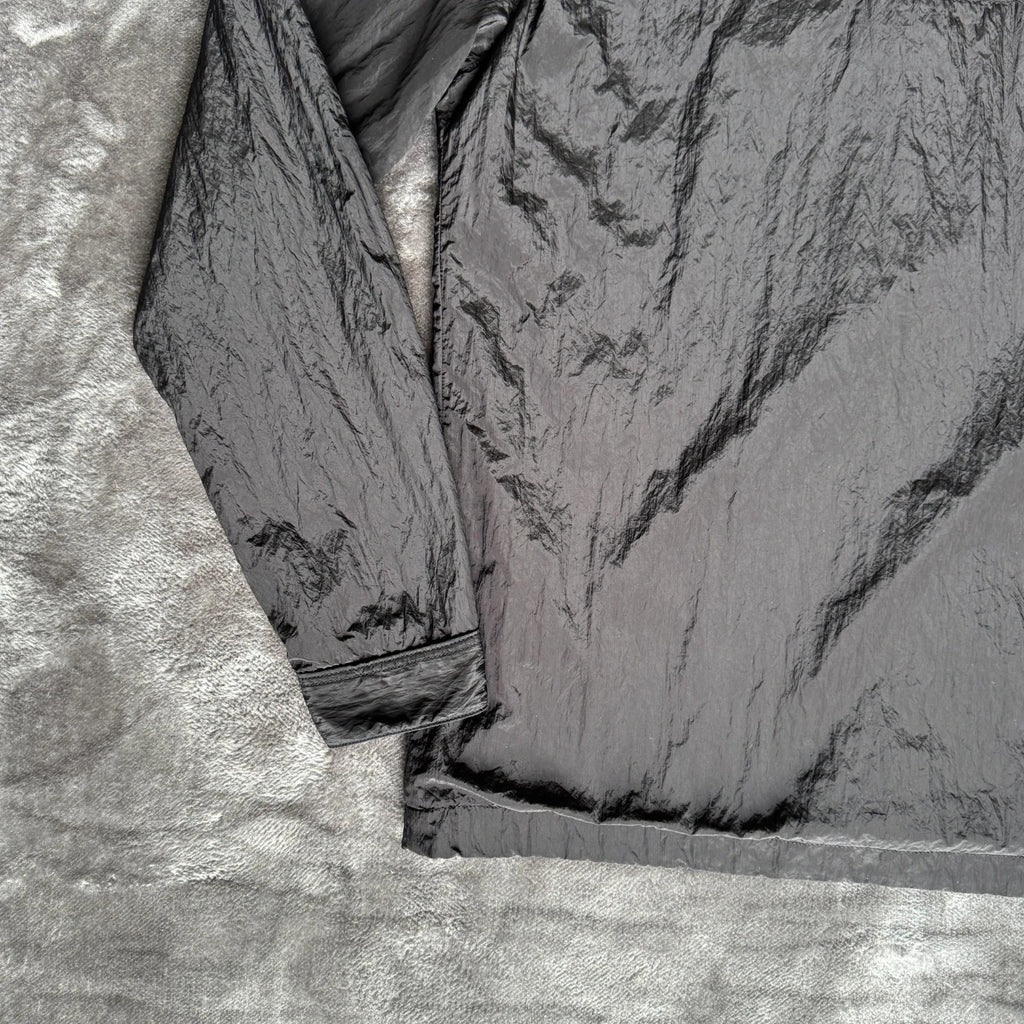 Stone Island black overshirt with logo badge and nylon metal material.