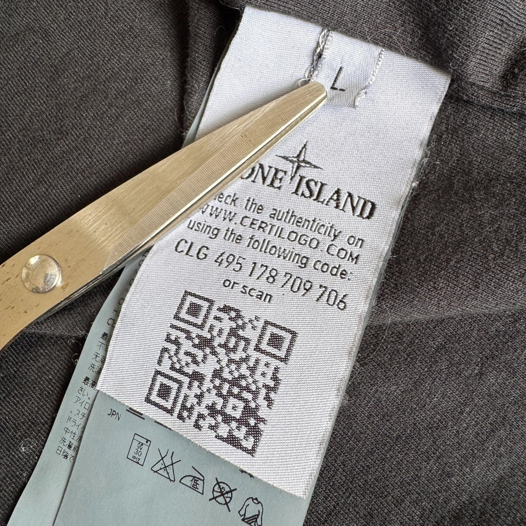 Stone Island black overshirt with logo badge and nylon metal material.