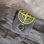 Stone Island black overshirt with logo badge and nylon metal material.