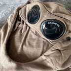 C.P. Company khaki goggle hoodie with side zip and logo detail.