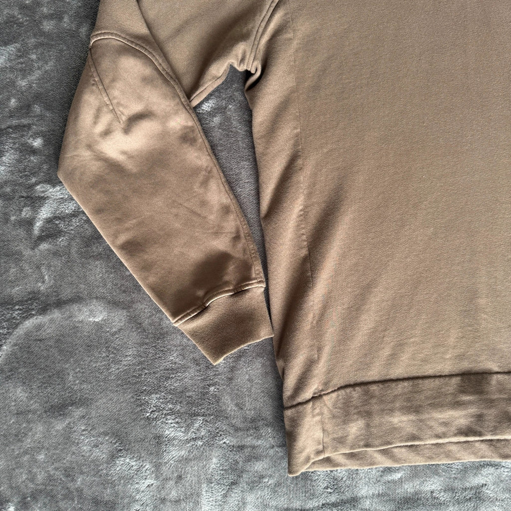 C.P. Company khaki goggle hoodie with side zip and logo detail.