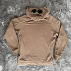 C.P. Company khaki goggle hoodie with side zip and logo detail.