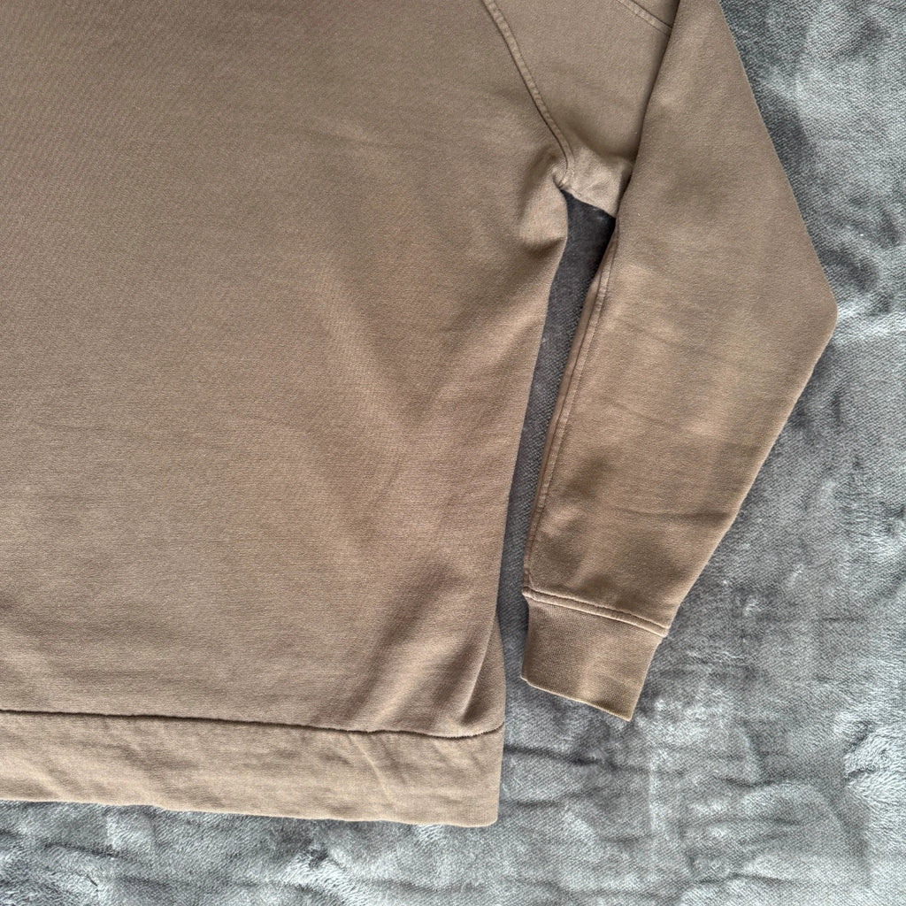 C.P. Company khaki goggle hoodie with side zip and logo detail.