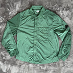 C.P. Company green overshirt with Chrome-R pocket and lens detail, brand new condition.