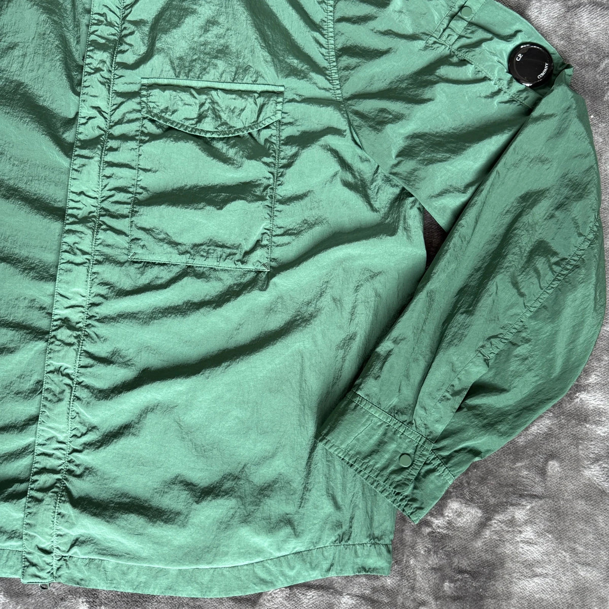 C.P. Company green overshirt with Chrome-R pocket and lens detail, brand new condition.