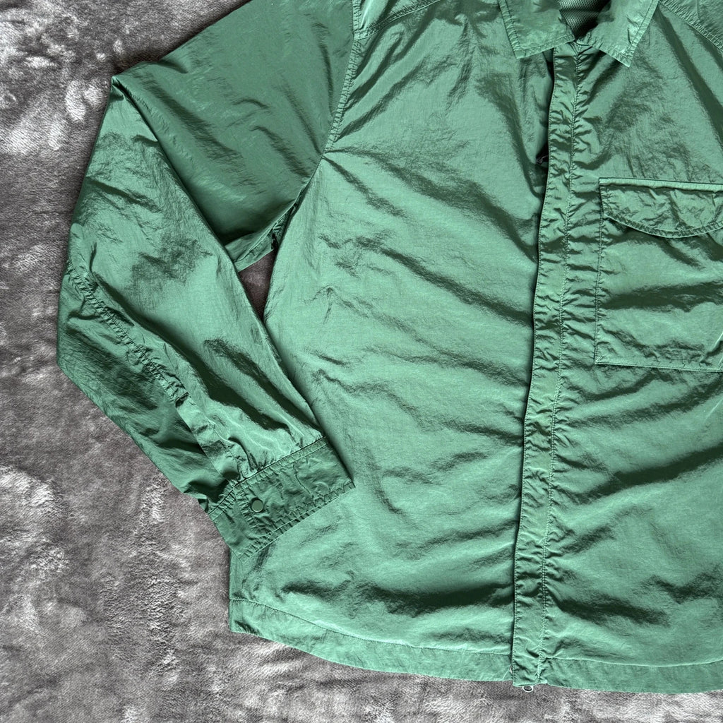 C.P. Company green overshirt with Chrome-R pocket and lens detail, brand new condition.