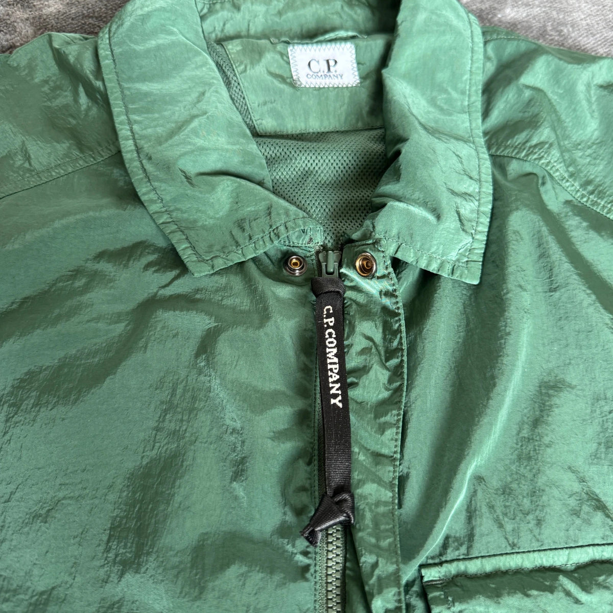 C.P. Company green overshirt with Chrome-R pocket and lens detail, brand new condition.