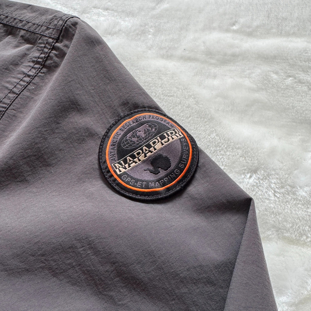 Napapijri grey pullover jacket with logo patch and ventilation zips, lightweight anorak design.