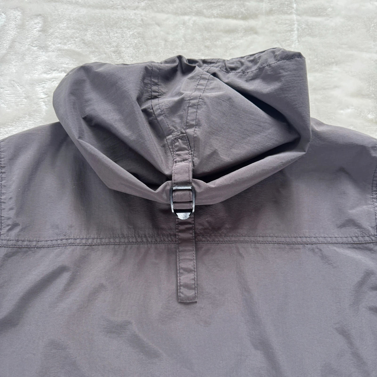 Napapijri grey pullover jacket with logo patch and ventilation zips, lightweight anorak design.