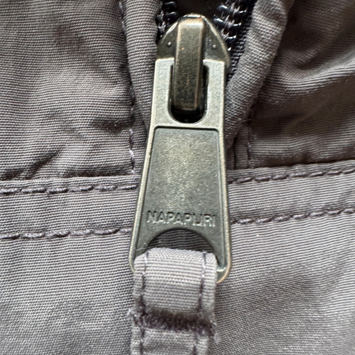 Napapijri grey pullover jacket with logo patch and ventilation zips, lightweight anorak design.