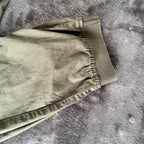 Stone Island khaki cuffed cargo trousers with logo patch and multiple pockets.