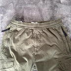 Stone Island khaki cuffed cargo trousers with logo patch and multiple pockets.