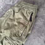 Stone Island khaki cuffed cargo trousers with logo patch and multiple pockets.