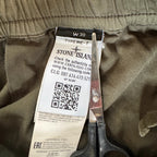 Stone Island khaki cuffed cargo trousers with logo patch and multiple pockets.