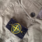 Stone Island khaki cuffed cargo trousers with logo patch and multiple pockets.