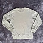 C.P. Company green sweatshirt with ribbed hem and signature goggle lens detail.