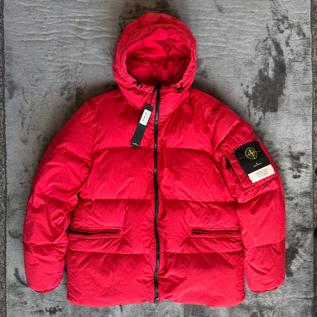 Stone Island red puffer jacket with compass patch, adjustable hood, and multiple pockets.