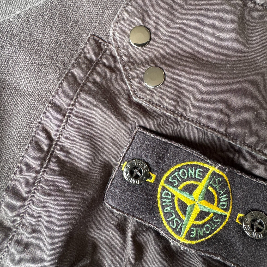 Stone Island black crewneck sweatshirt with zipped pocket and iconic compass logo.