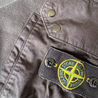 Stone Island black crewneck sweatshirt with zipped pocket and iconic compass logo.