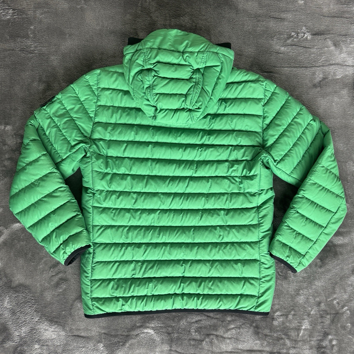 Stone Island green down jacket with logo patch and 0-cotton/R-nylon material.