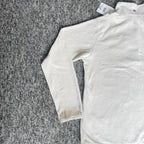 Berghaus off-white half-zip fleece with black logo pocket and stand-up collar.