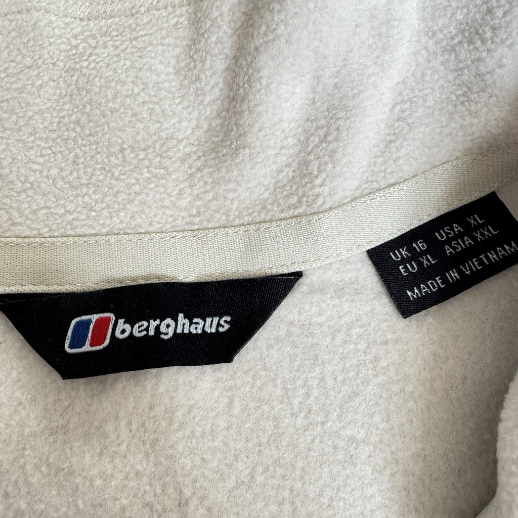 Berghaus off-white half-zip fleece with black logo pocket and stand-up collar.