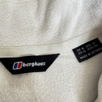 Berghaus off-white half-zip fleece with black logo pocket and stand-up collar.