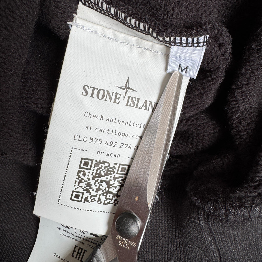 Stone Island black crewneck sweatshirt with zipped pocket and iconic compass logo.