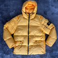 Stone Island yellow down jacket with crinkle reps texture and iconic compass logo.