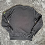 Stone Island black crewneck sweatshirt with zipped pocket and iconic compass logo.