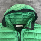 Stone Island green down jacket with logo patch and 0-cotton/R-nylon material.