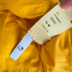 Stone Island yellow down jacket with crinkle reps texture and iconic compass logo.