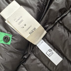 Stone Island green down jacket with logo patch and 0-cotton/R-nylon material.