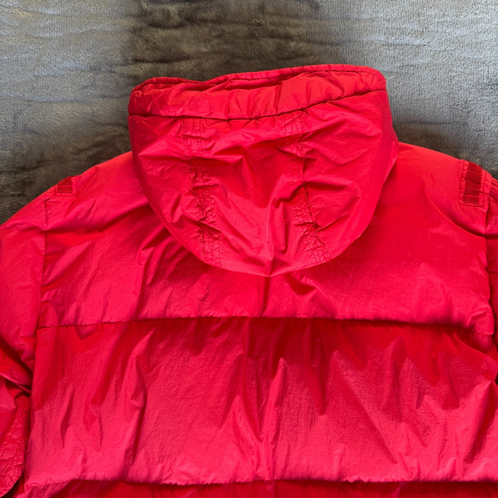 Stone Island red puffer jacket with compass patch, adjustable hood, and multiple pockets.