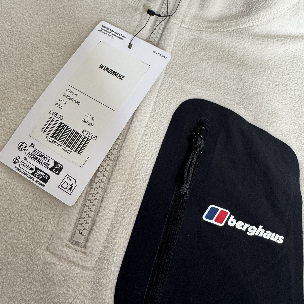 Berghaus off-white half-zip fleece with black logo pocket and stand-up collar.