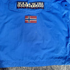 Napapijri blue anorak jacket with logo chest flap and quarter-zip front closure.