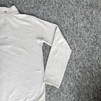 Berghaus off-white half-zip fleece with black logo pocket and stand-up collar.