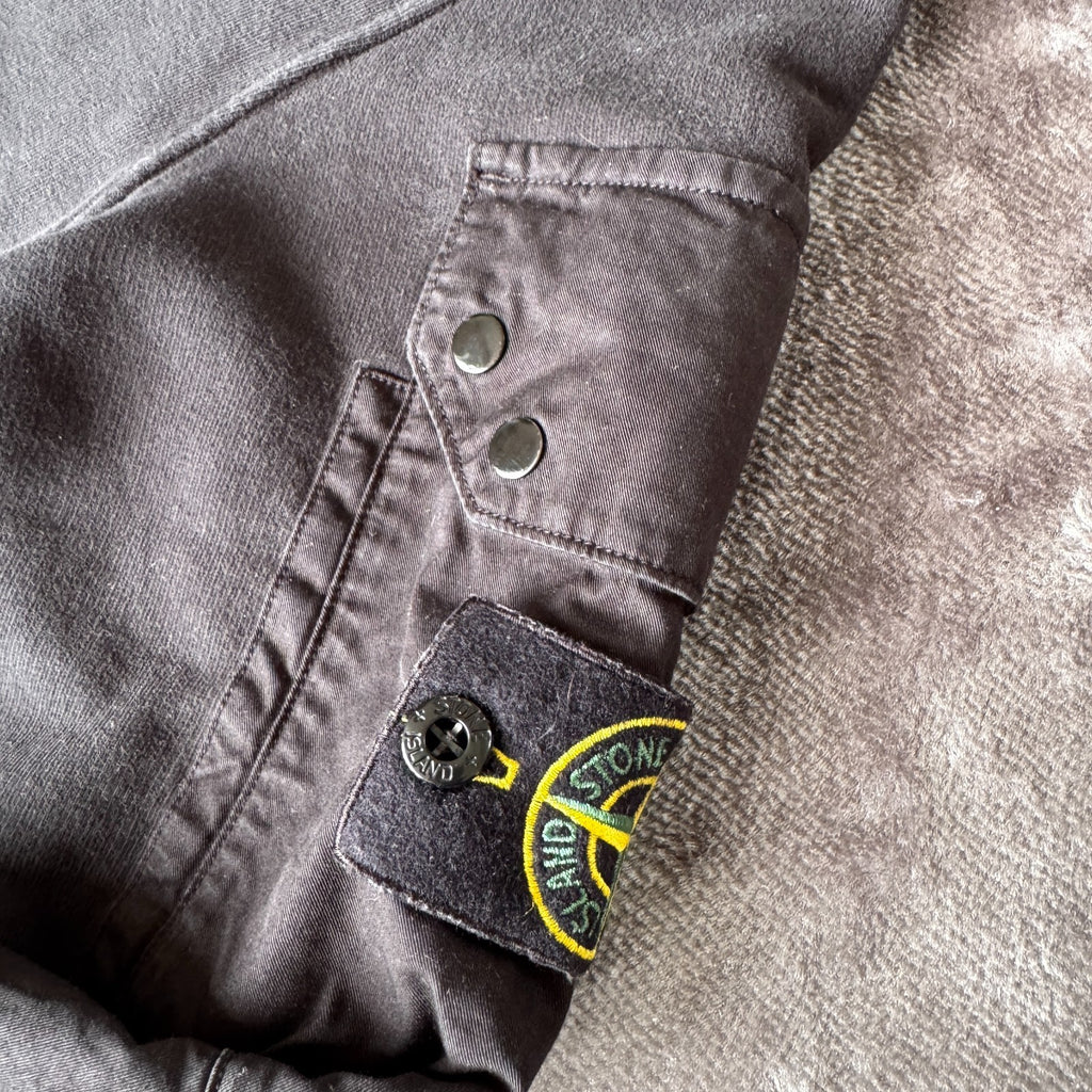Stone Island black crewneck sweatshirt with zipped pocket and iconic compass logo.