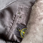 Stone Island black crewneck sweatshirt with zipped pocket and iconic compass logo.
