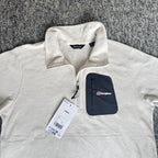 Berghaus off-white half-zip fleece with black logo pocket and stand-up collar.