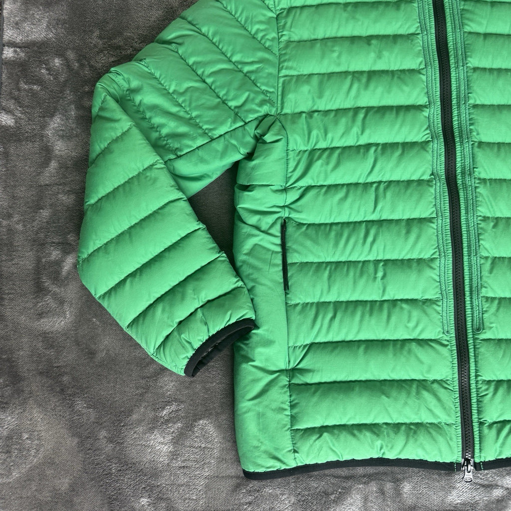 Stone Island green down jacket with logo patch and 0-cotton/R-nylon material.