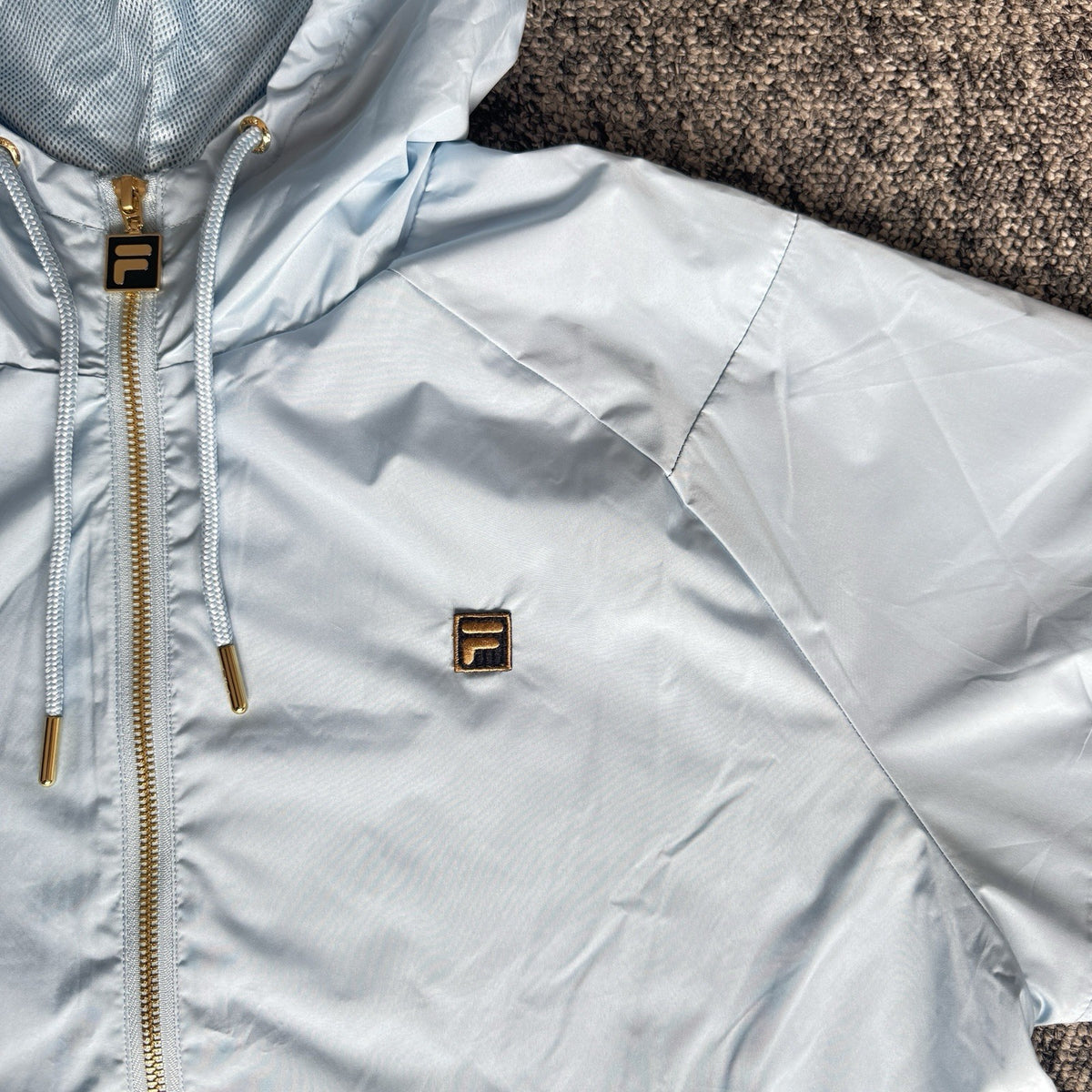 Fila lightweight hooded jacket light sky blue embroidered chest logo gold-tone zip hardware