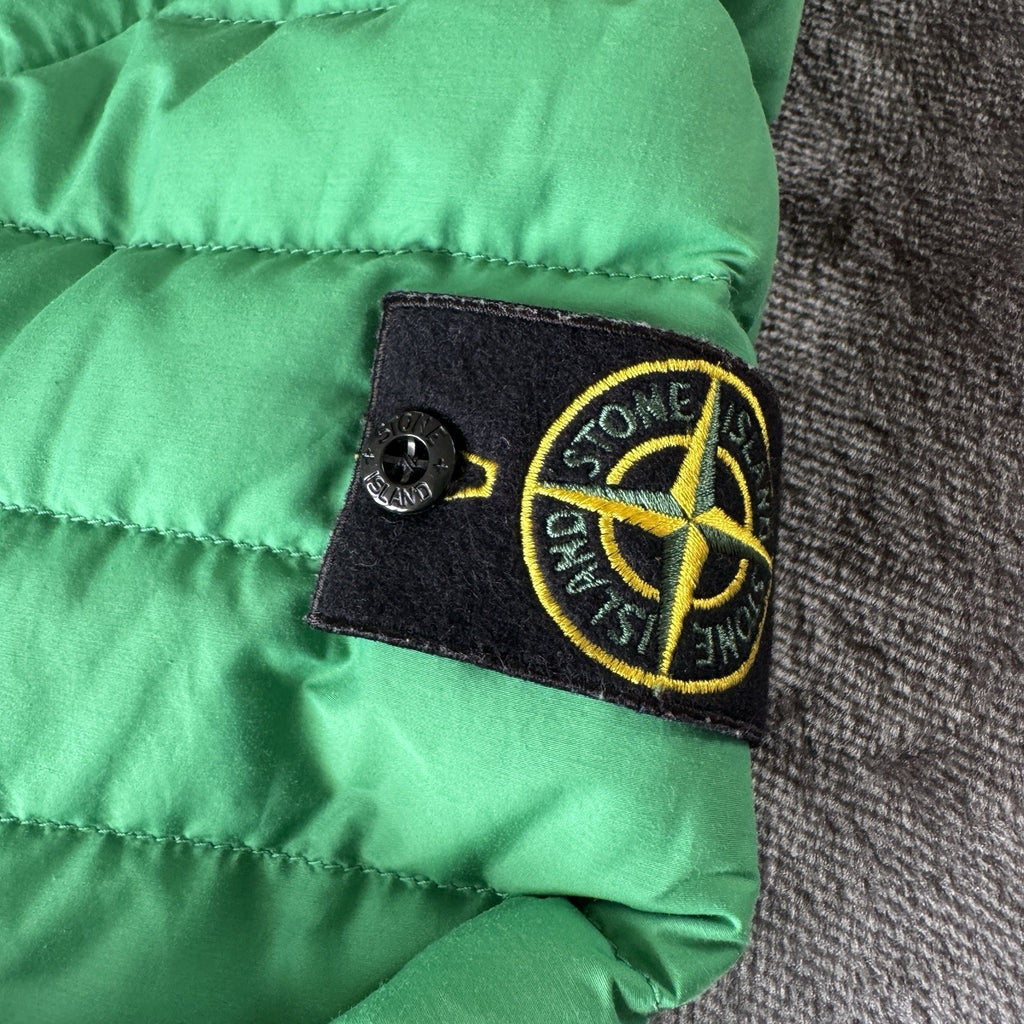 Stone Island green down jacket with logo patch and 0-cotton/R-nylon material.