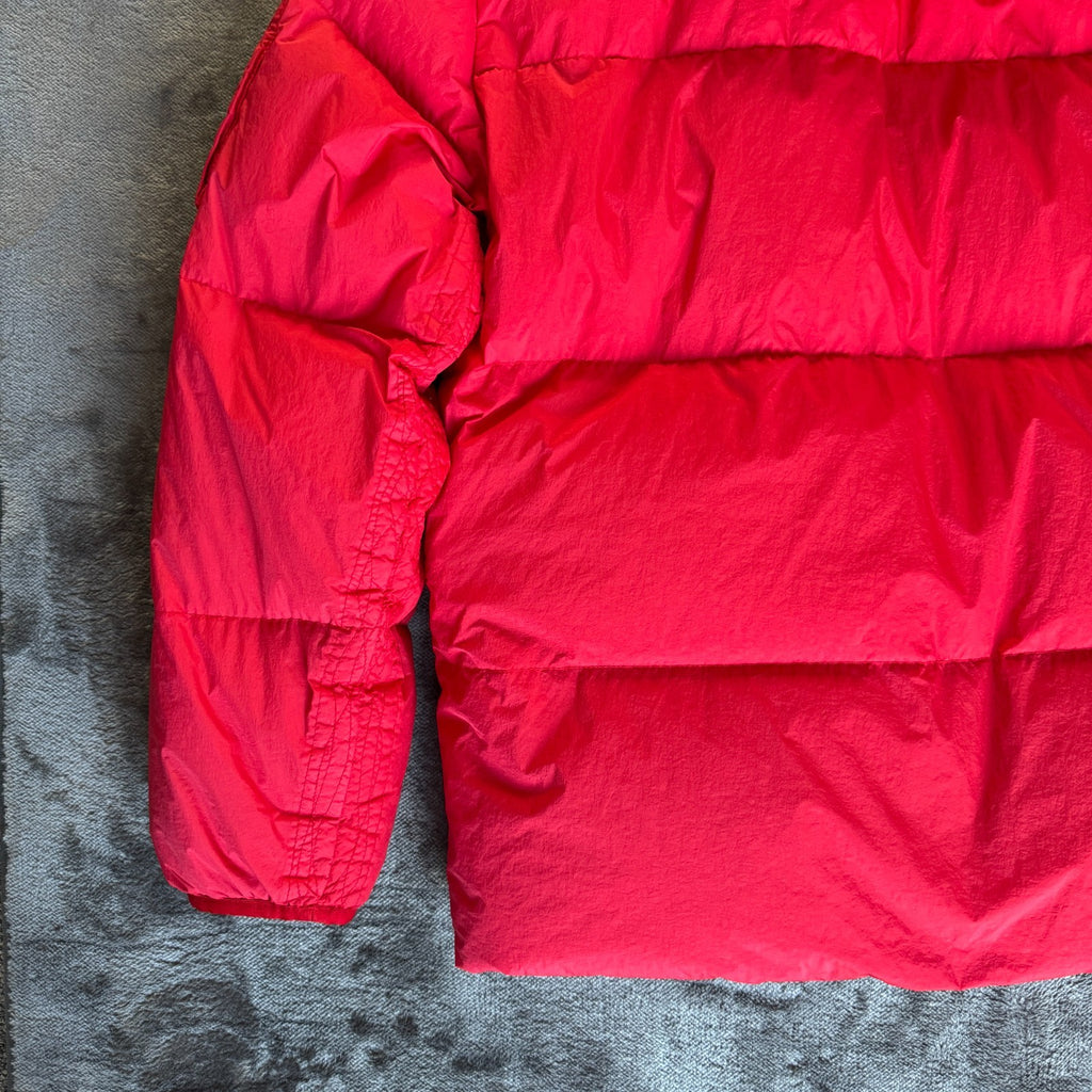 Stone Island red puffer jacket with compass patch, adjustable hood, and multiple pockets.