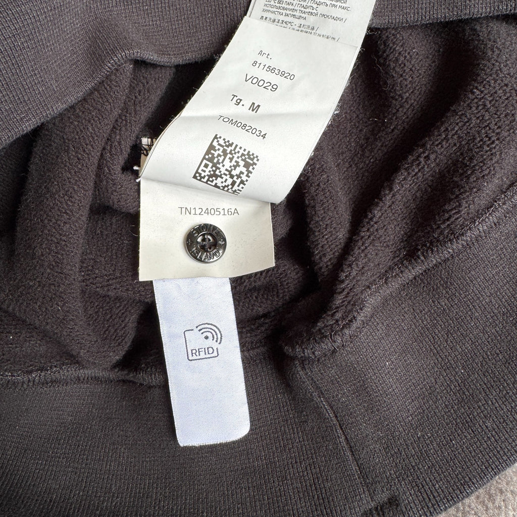 Stone Island black crewneck sweatshirt with zipped pocket and iconic compass logo.