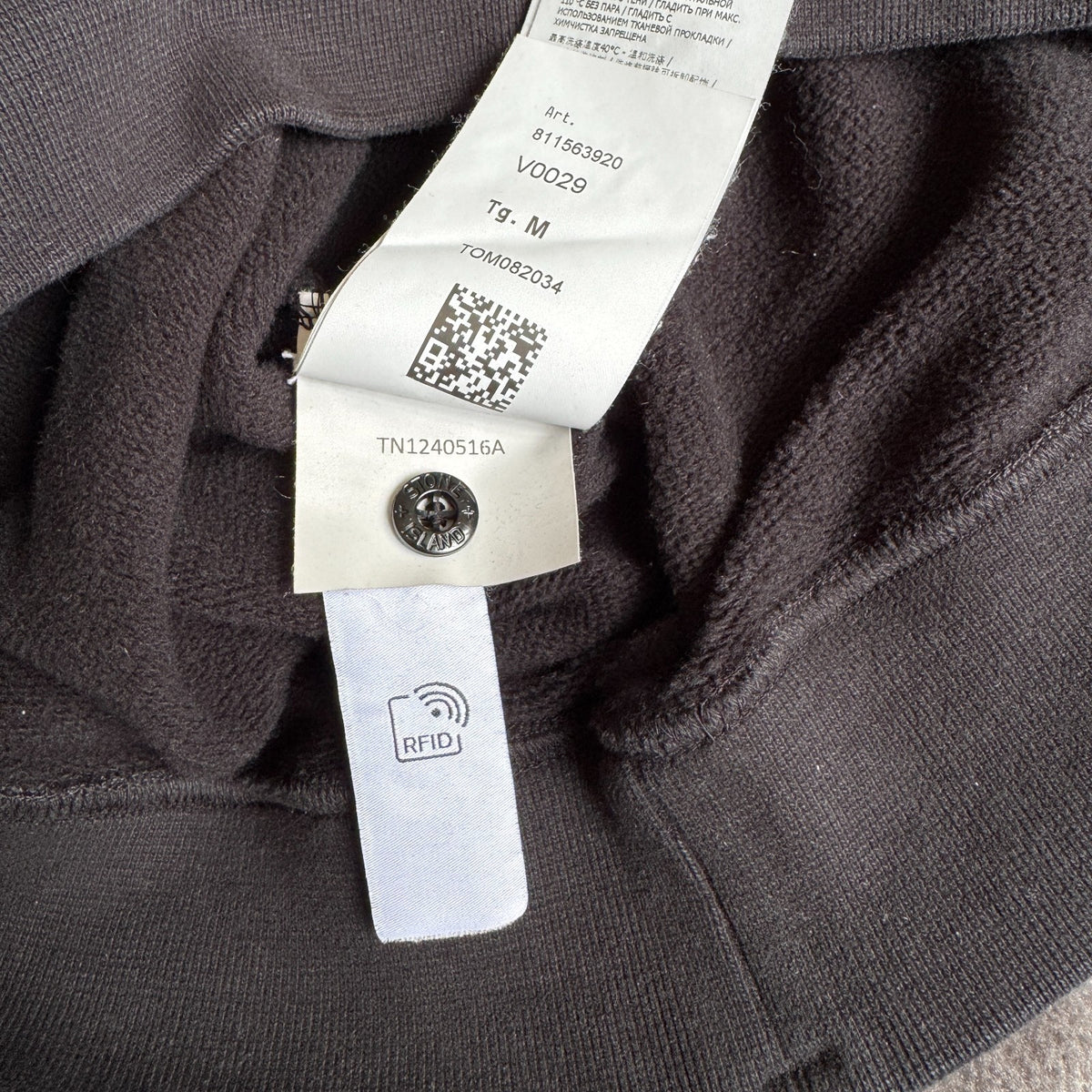 Stone Island black crewneck sweatshirt with zipped pocket and iconic compass logo.