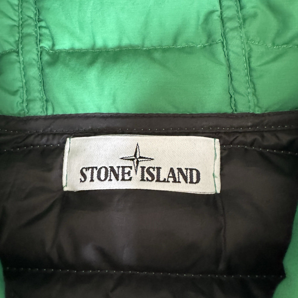 Stone Island green down jacket with logo patch and 0-cotton/R-nylon material.