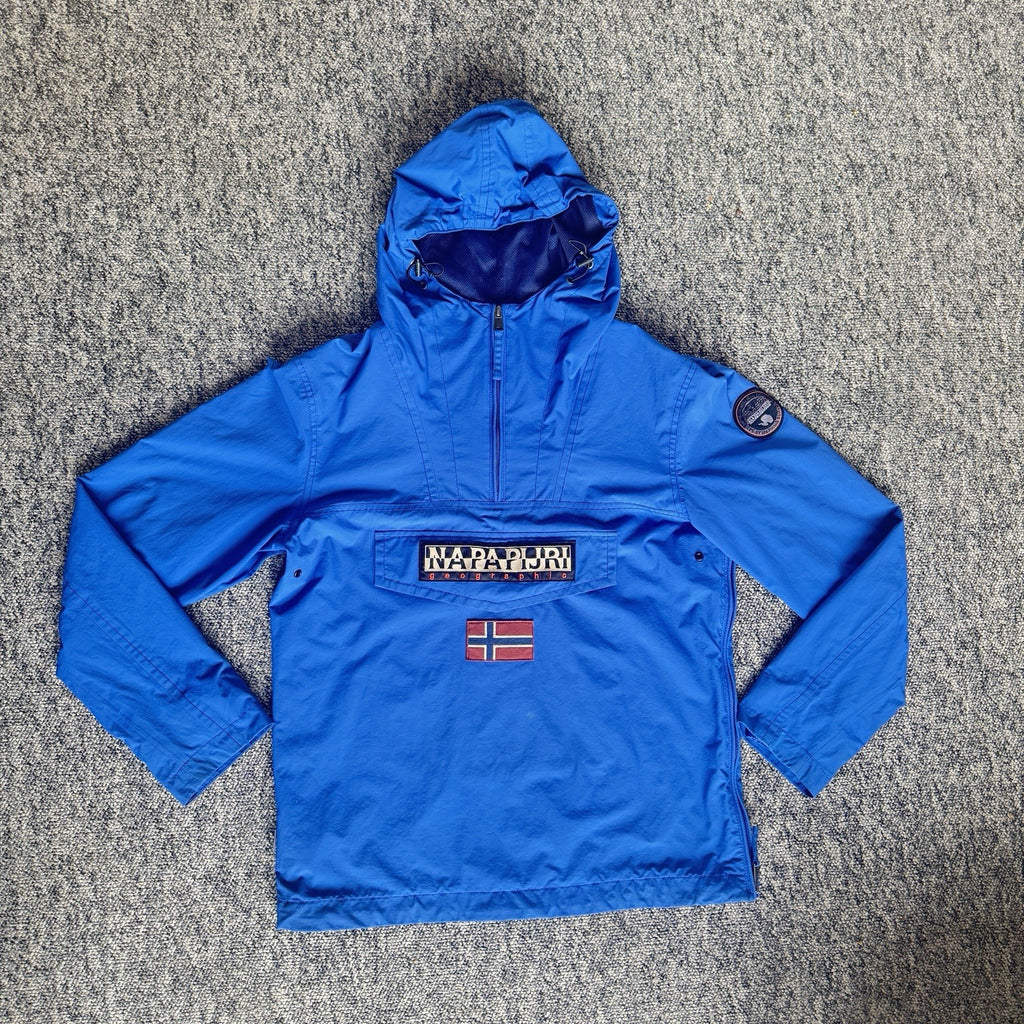Napapijri blue anorak jacket with logo chest flap and quarter-zip front closure.
